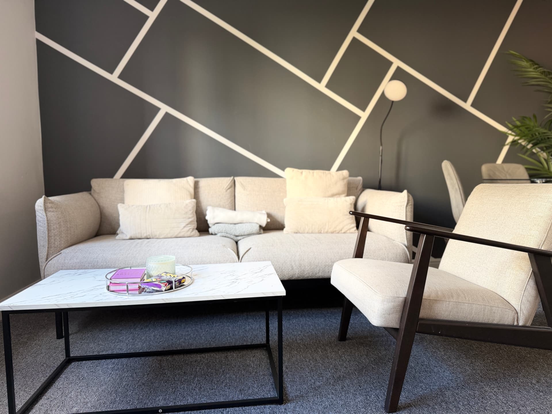 Century House lounge with comfortable sofa, armchair and coffee table