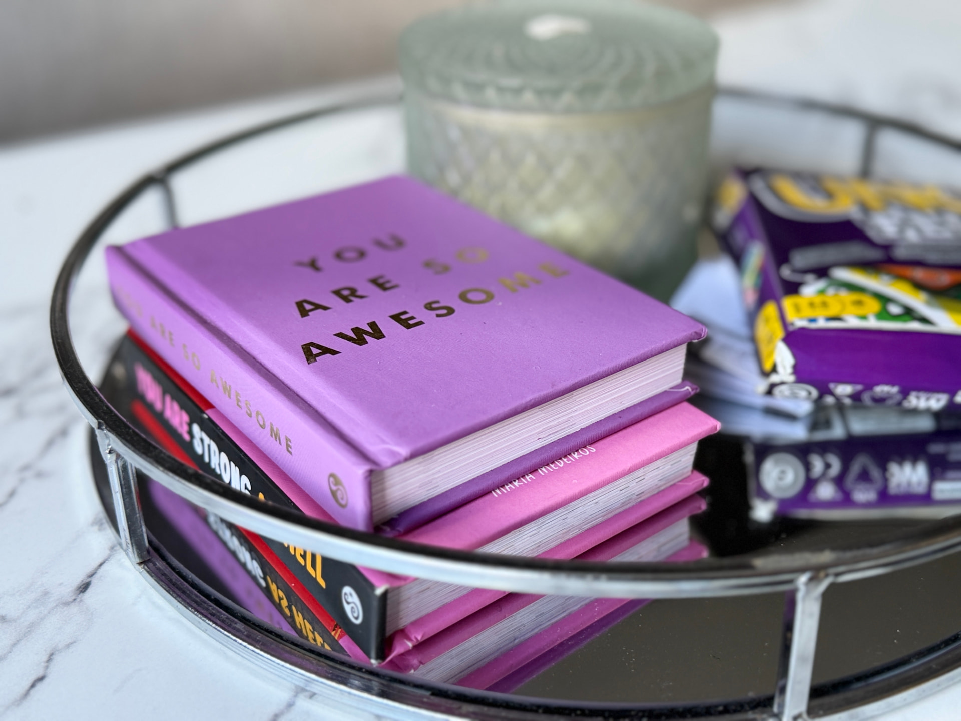 Books, games and a candle arranged for Century House guests