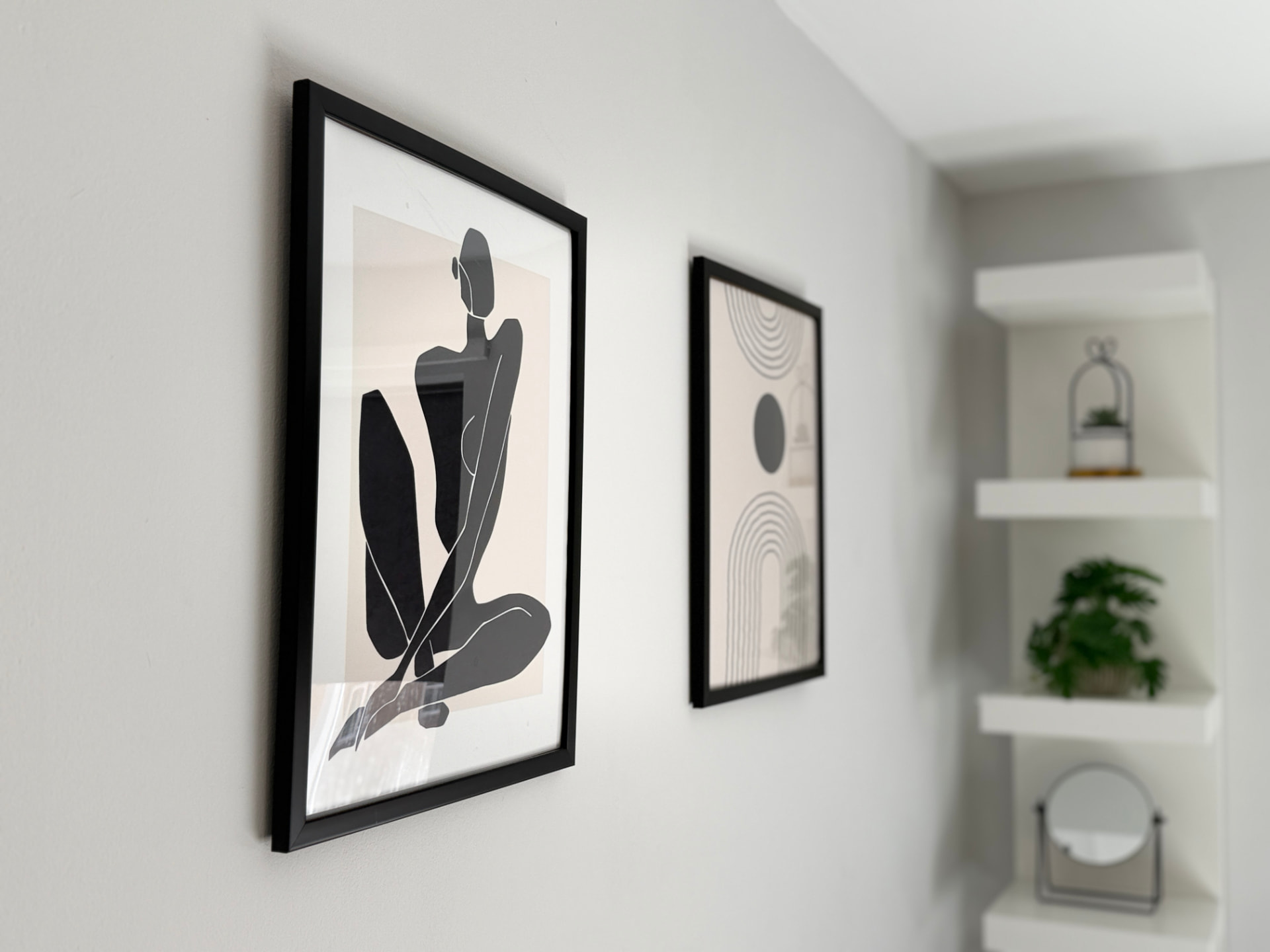 Century House minimalist framed artwork beside built-in display shelves