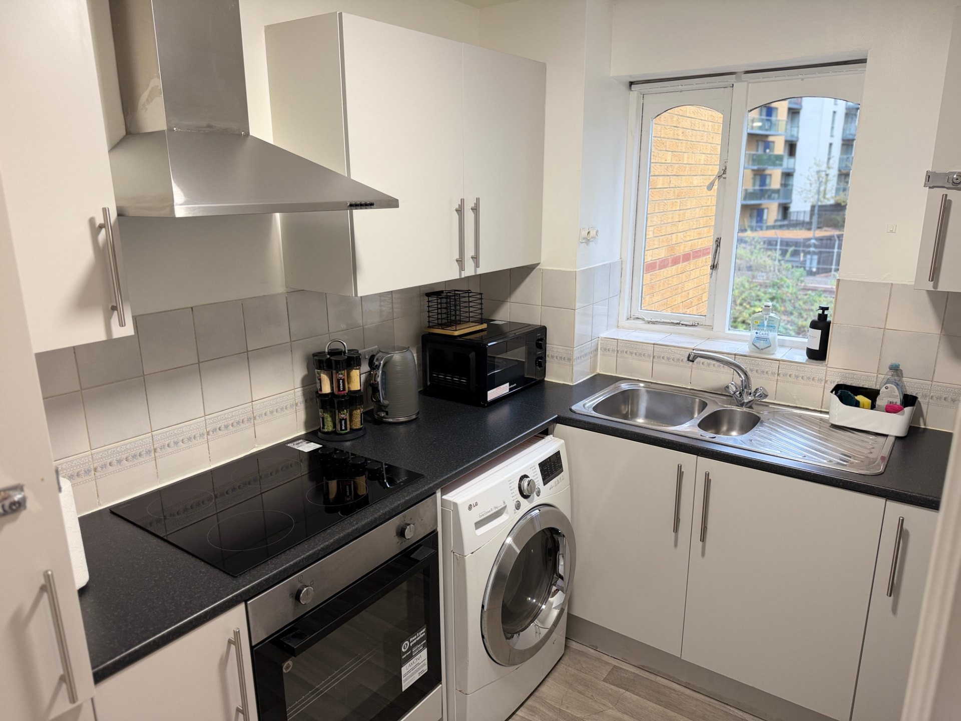 Century House kitchen with induction hob, oven, microwave and washer-dryer